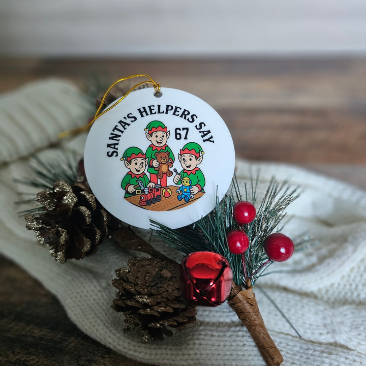 Christmas ornament with cartoon elves and pine cones on a textured surface