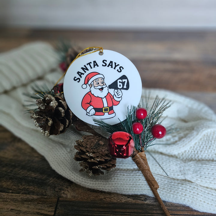 Christmas ornament with Santa Claus and pine cones on a wooden surface