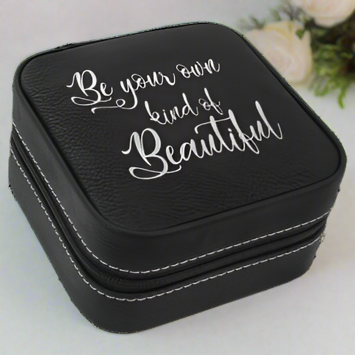 Black jewelry box with 'Be your own kind of beautiful' text on a white background