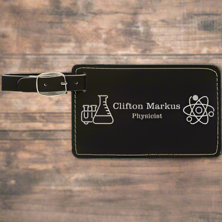 Black luggage tag with engraved text and symbols on a white background