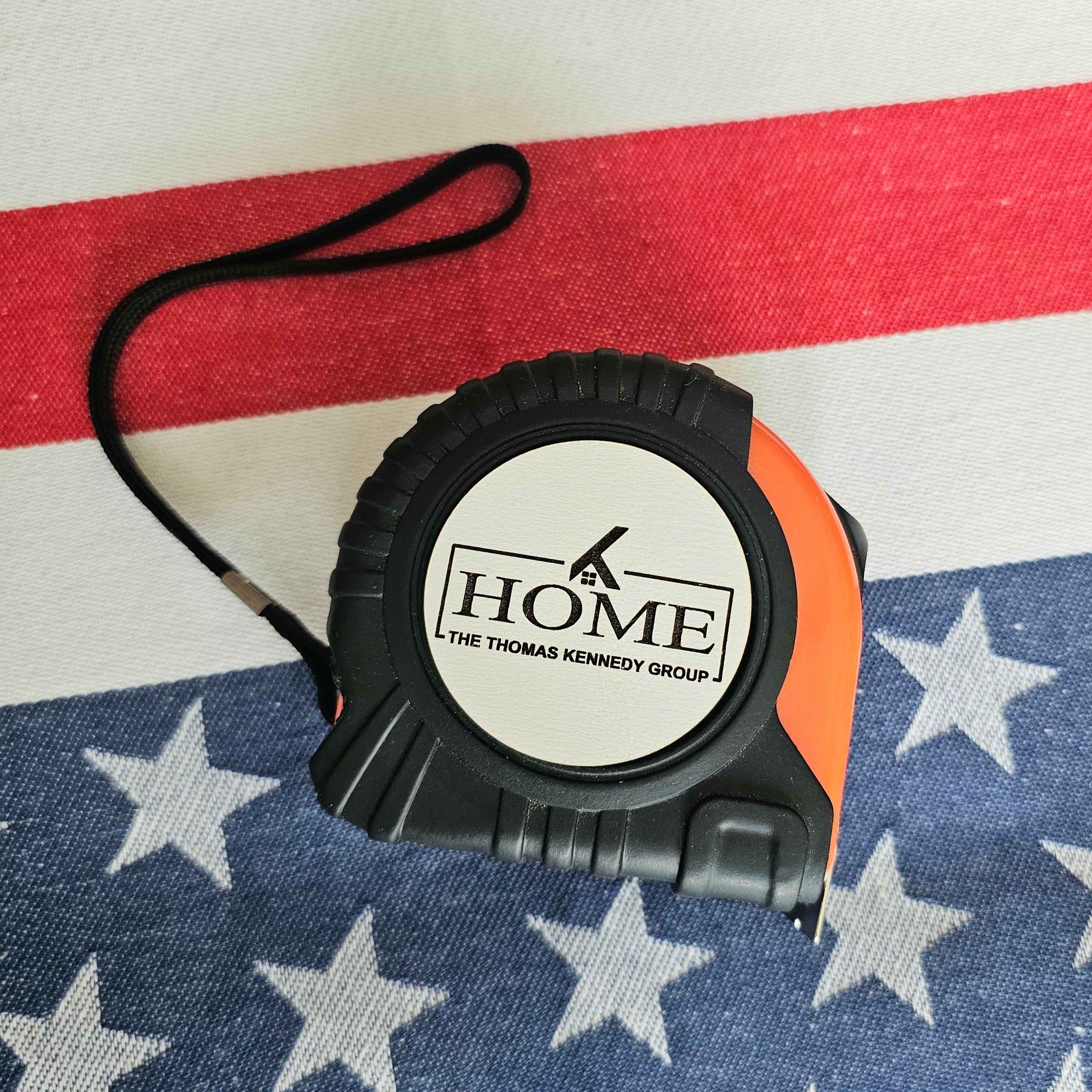 Tape measure with 'HOME' branding on an American flag background