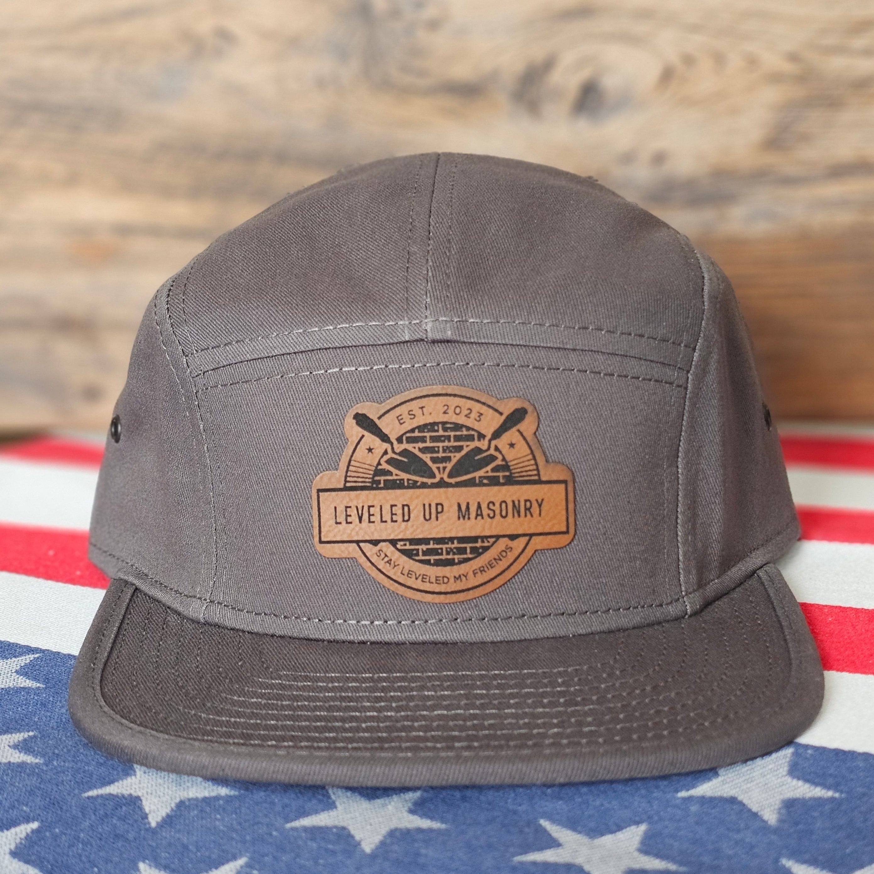 Gray cap with a leather patch on an American flag background