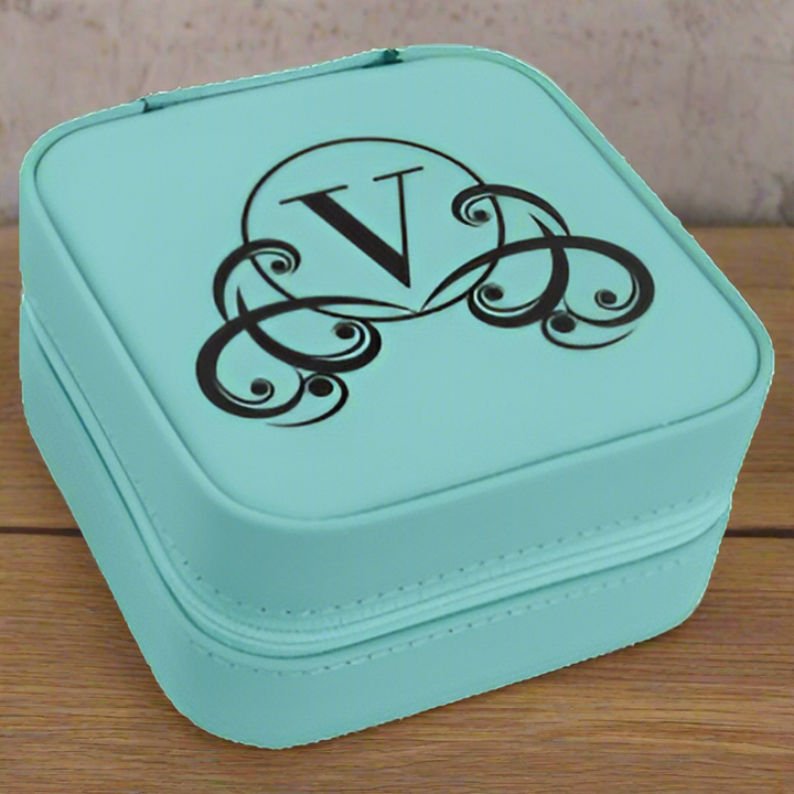 Turquoise jewelry box with a decorative 'V' monogram on a white background